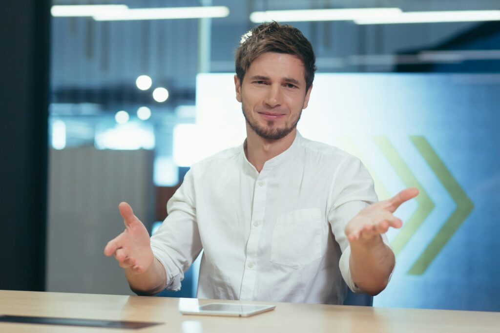 Man in office working surprised looking at webcam web, online conference with colleagues